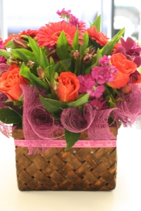 Mixed spring flowers in a rattan box